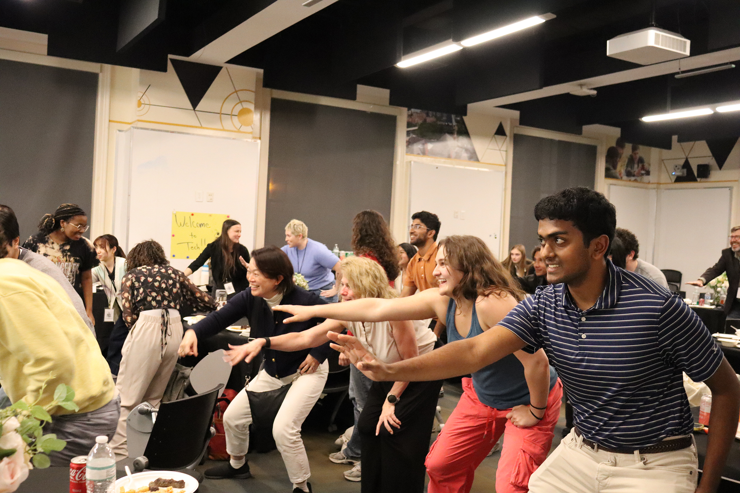 a large group of college students laughing and dancing